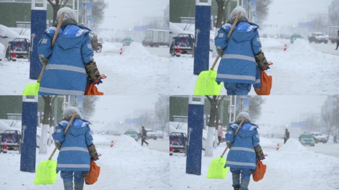 环卫工人在雪中艰难行走背影