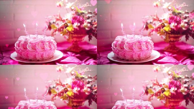 粉红色的生日蛋糕上燃烧的蜡烛