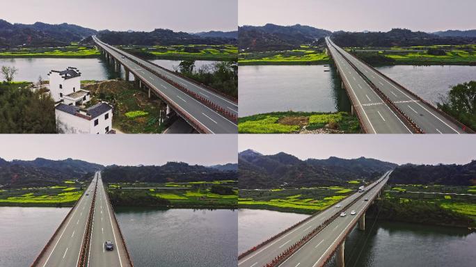 4K航拍高速公路穿过油菜花田和大江