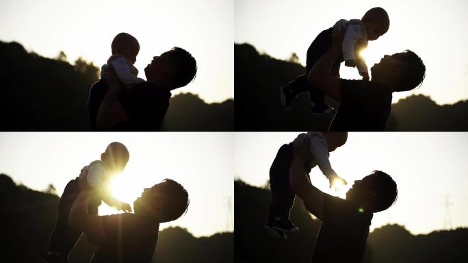 父子夕阳下的婴儿与父亲父亲节意境唯美父子