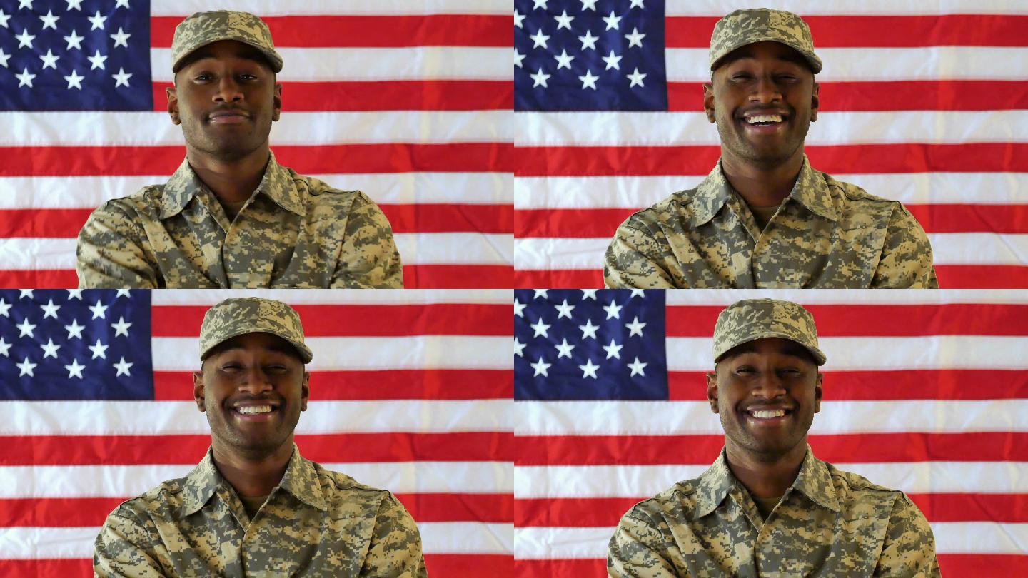 美国士兵站在美国国旗前自信地微笑