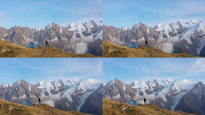 在勃朗峰附近旅行者站在蓝色帐篷外