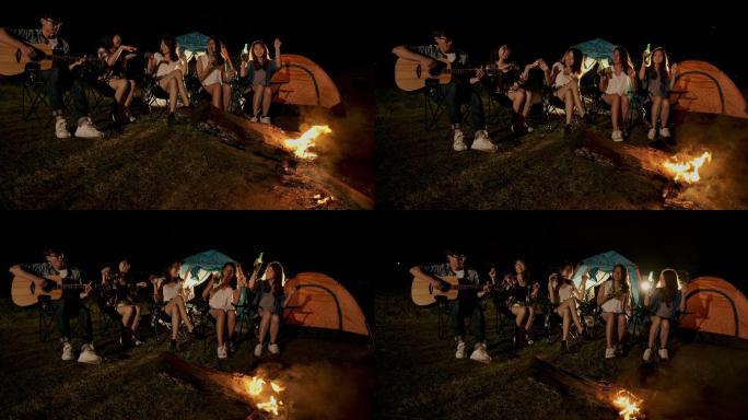 一群朋友在野营旅行中唱歌和喝啤酒