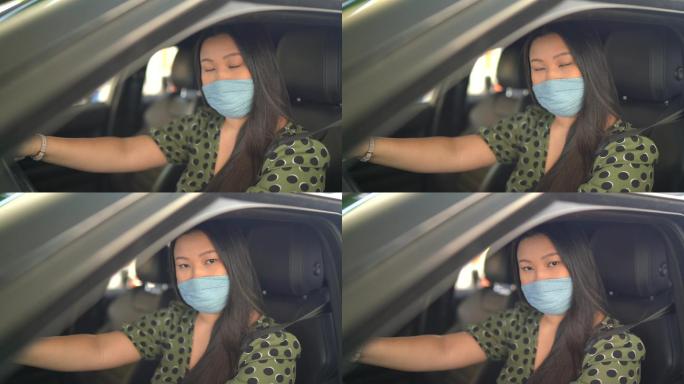在加油站，一名年轻女子戴着面罩在车内