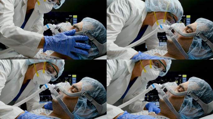 女医生在连接呼吸机时检查新冠病毒-19感染患者