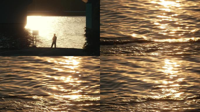 夕阳下江边钓鱼的人剪影
