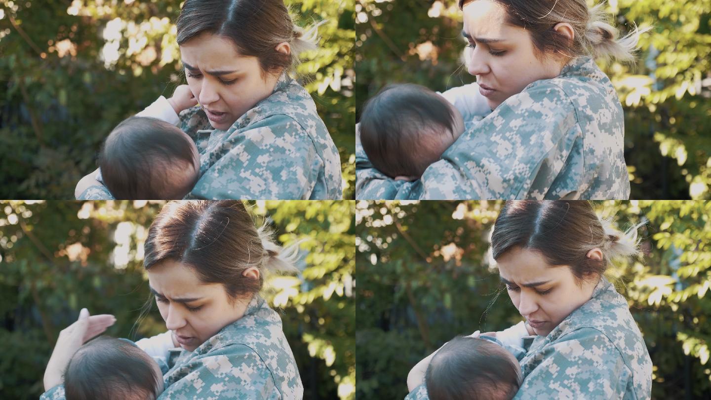 这名女兵在去执行军事任务前摇晃她的婴儿