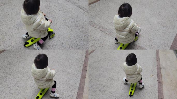 儿童骑滑板车玩耍