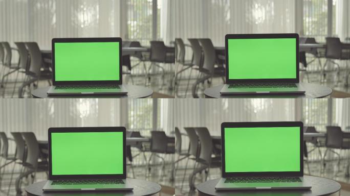 办公室内的绿屏笔记本电脑