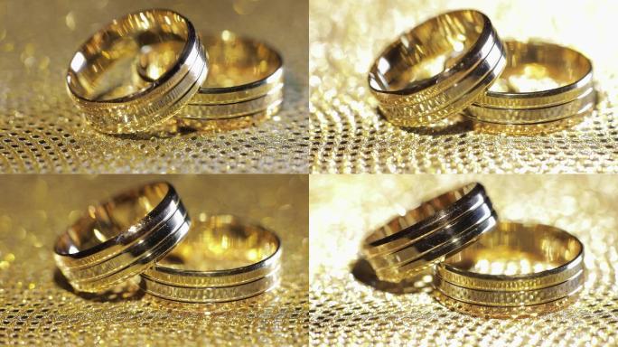 婚礼金戒指放在有光泽的表面上