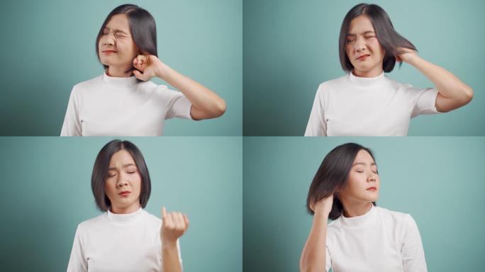 一名亚洲妇女将手指伸进耳朵