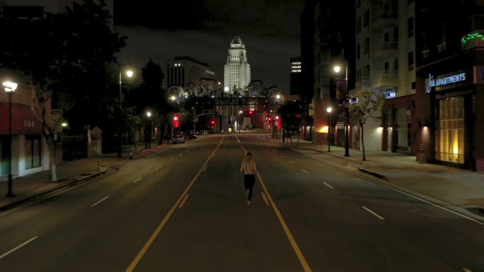 一个女人在空旷的城市街道上独自奔跑