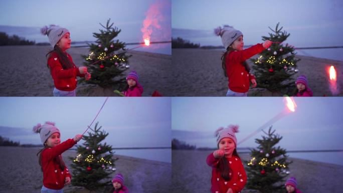 可爱的兄弟姐妹在海滩上的圣诞树旁欢度新年