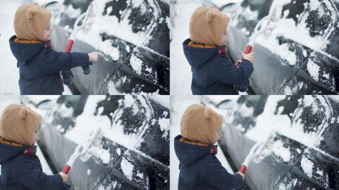 一个小男孩正在帮助清理汽车上的积雪