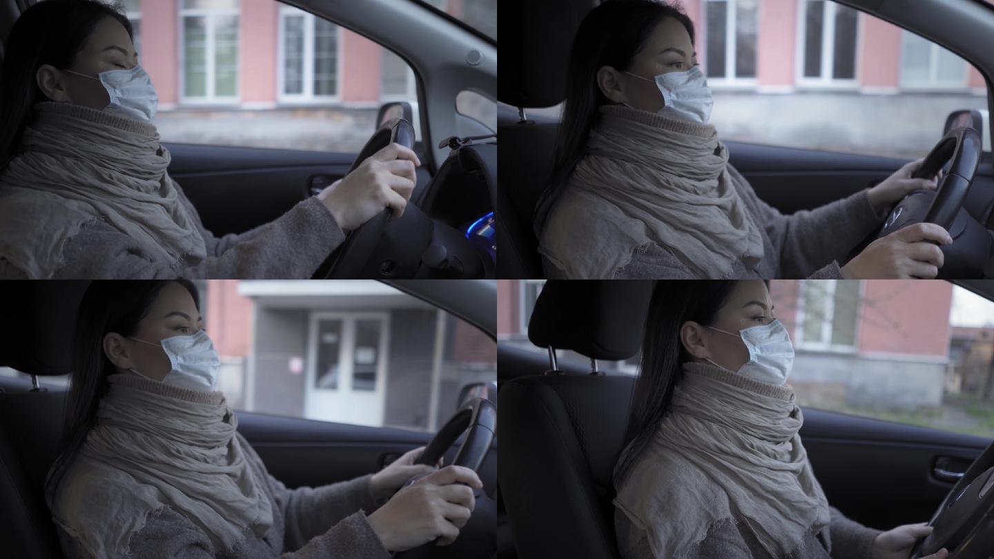 年轻女人戴着口罩开车
