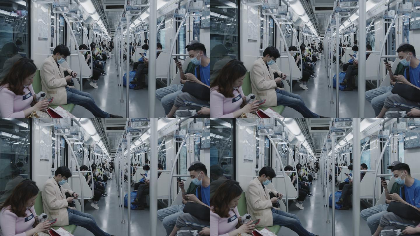 地铁行进时车厢内镜头看手机