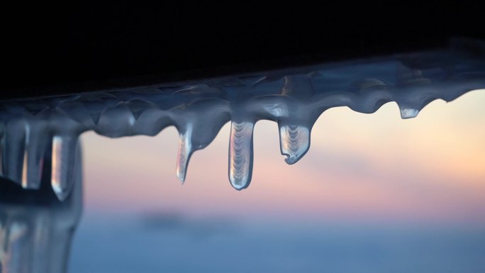 落日背景上的冰柱结冰冰棱冬季寒冷