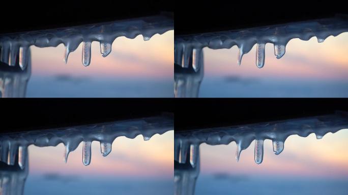 落日背景上的冰柱结冰冰棱冬季寒冷