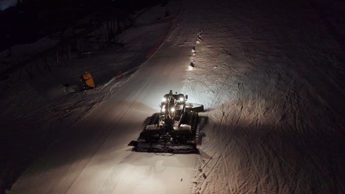 扫雪机在晚上清理路面鸟瞰图。