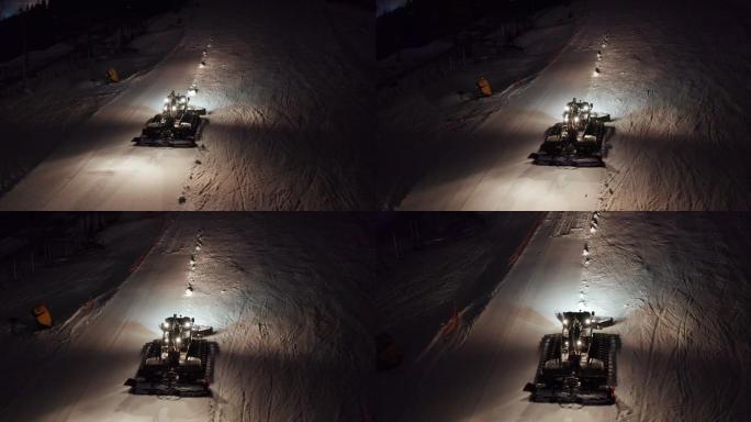 扫雪机在晚上清理路面鸟瞰图。