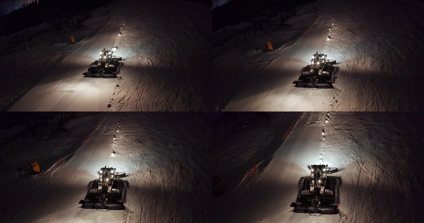 扫雪机在晚上清理路面鸟瞰图。