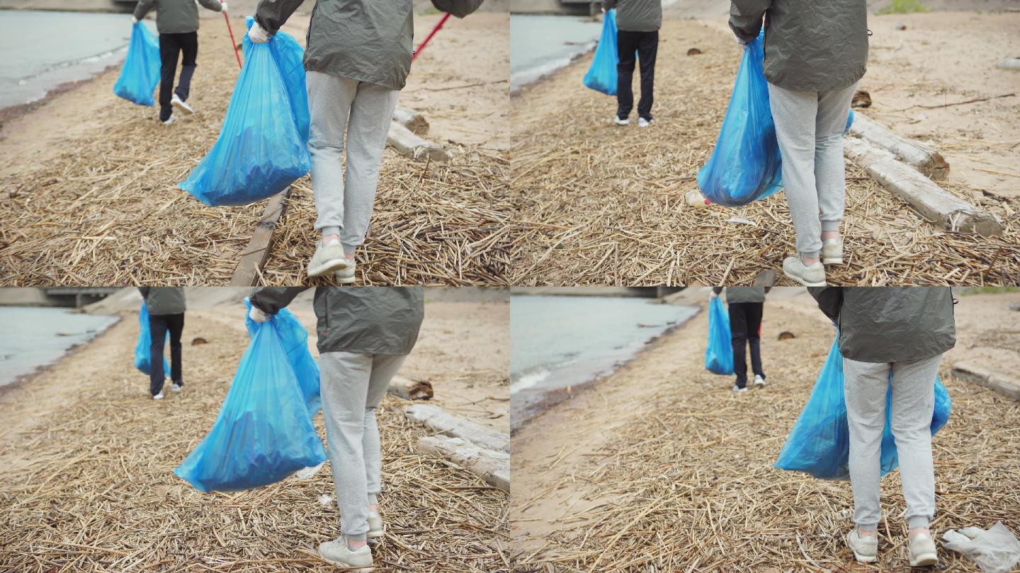 志愿者沿着海岸线收集垃圾