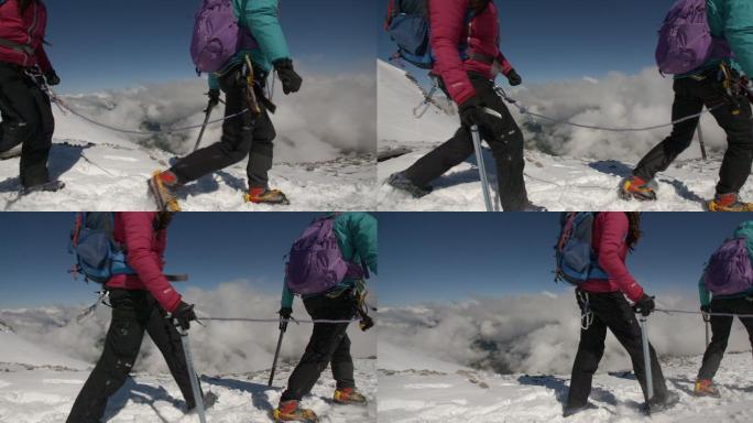 两名女登山家用绳子系在一起