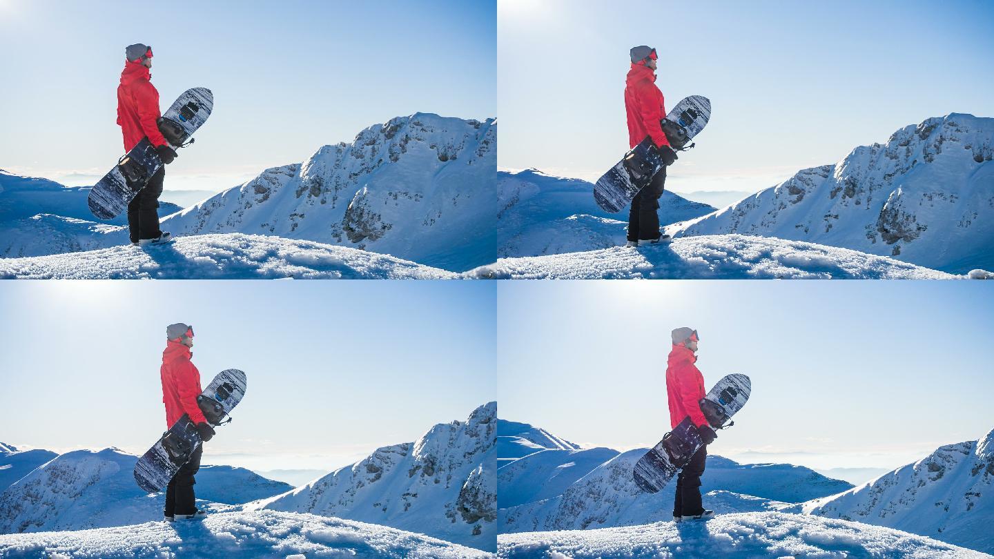 滑雪者站在雪山的顶部看风景