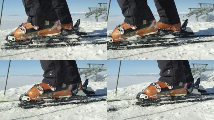滑雪者用他的滑雪靴踩入滑雪绑定