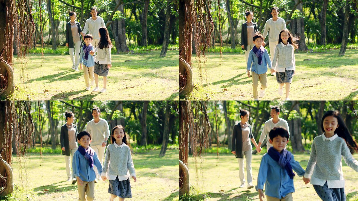 亚洲家庭带着两个孩子在公园散步