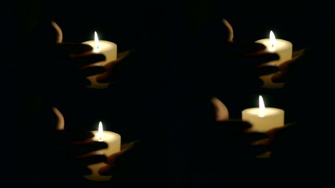 保护蜡烛火焰的手夜景视频素材温暖悲伤照明