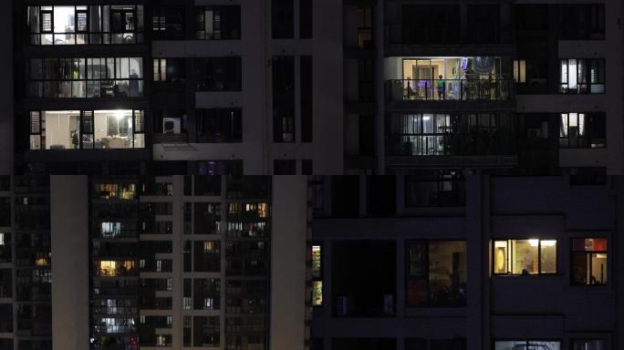 夜晚居民小区窗户阳台忙碌的家人居民