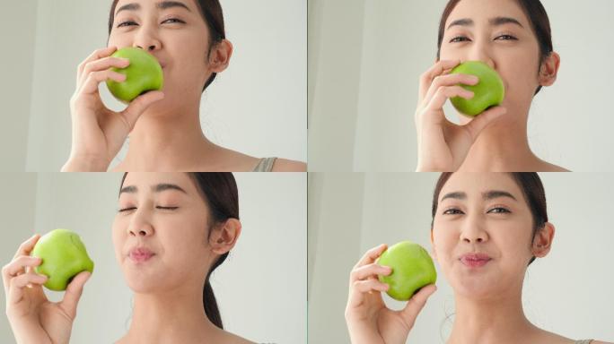 亚洲美女吃着青苹果