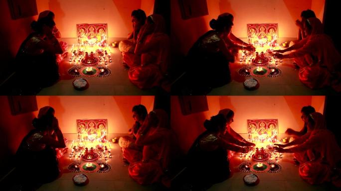 排灯节上，印度传统妇女在家敬拜