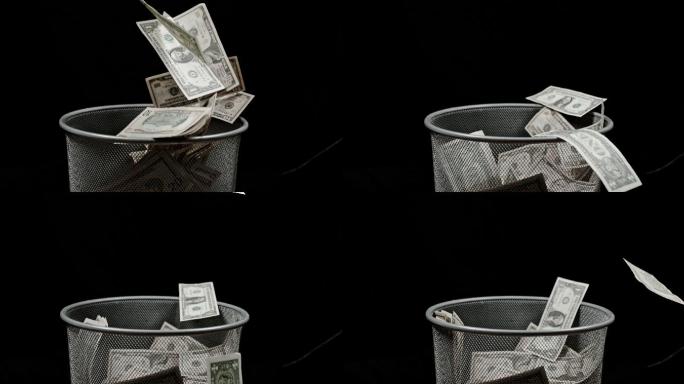 超慢镜头的美元钞票落入废纸篓。
