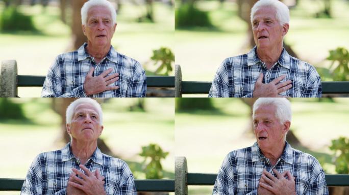 一名老年男子坐在长椅上心脏病发作