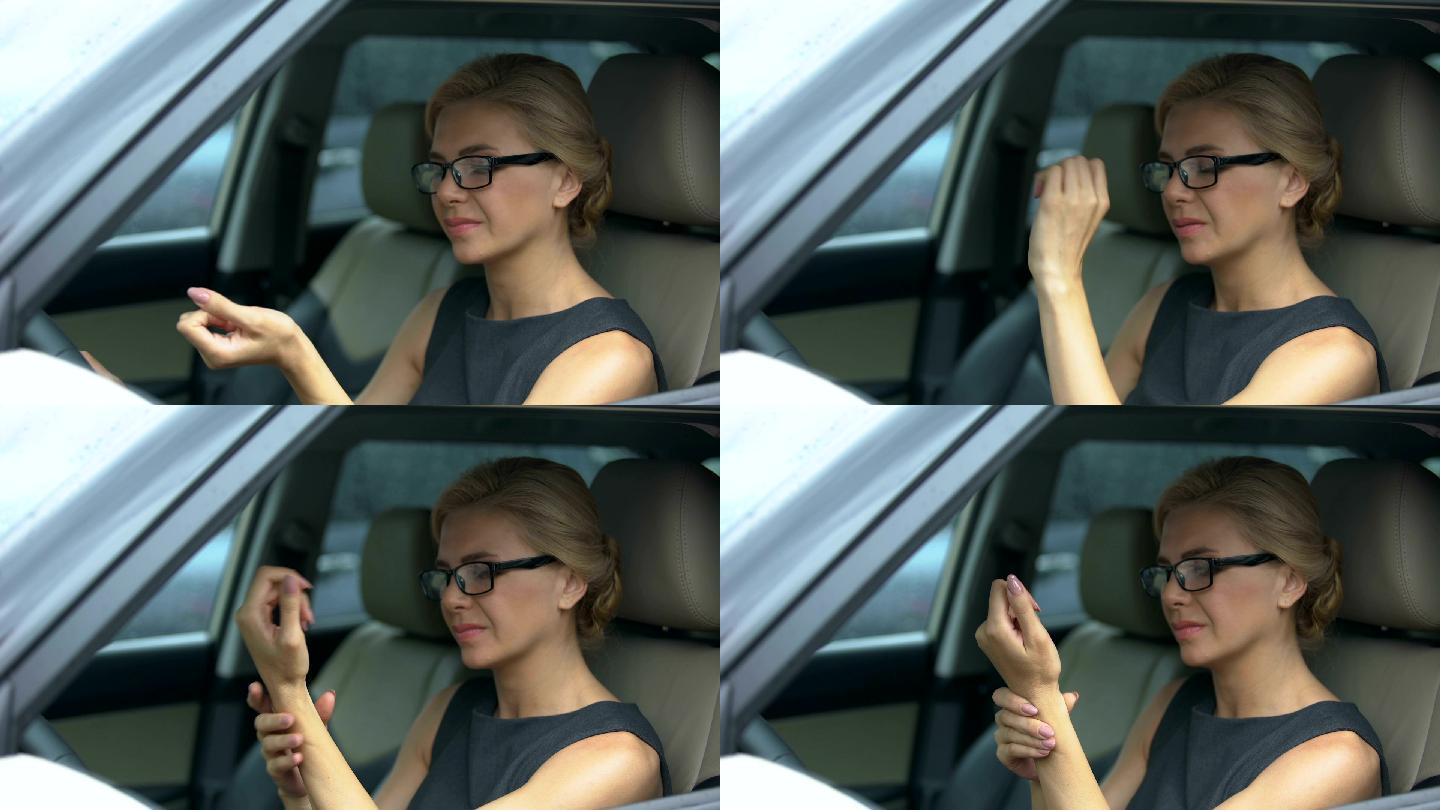 美女戴眼镜坐在车里，手腕疼痛