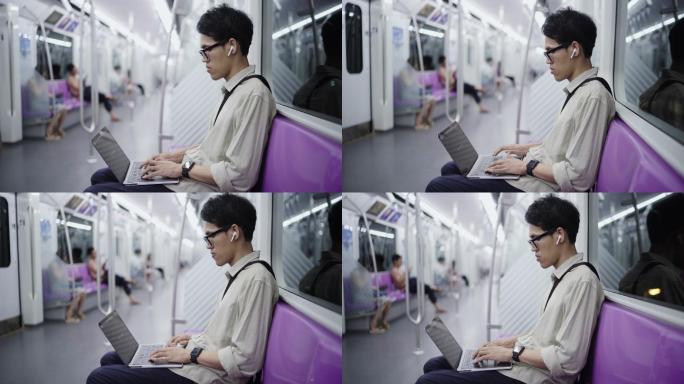 在火车上使用电脑发短信的人