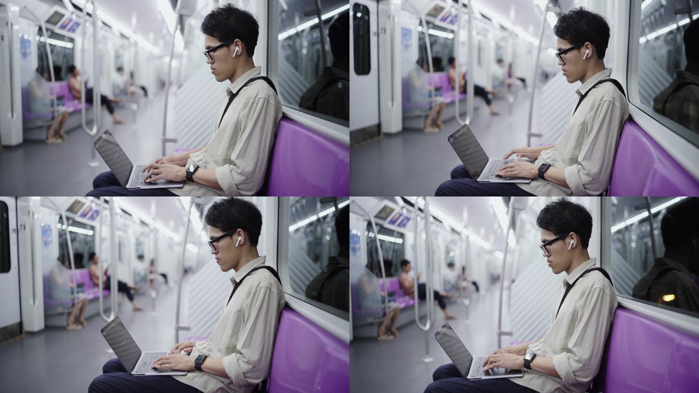 在火车上使用电脑发短信的人