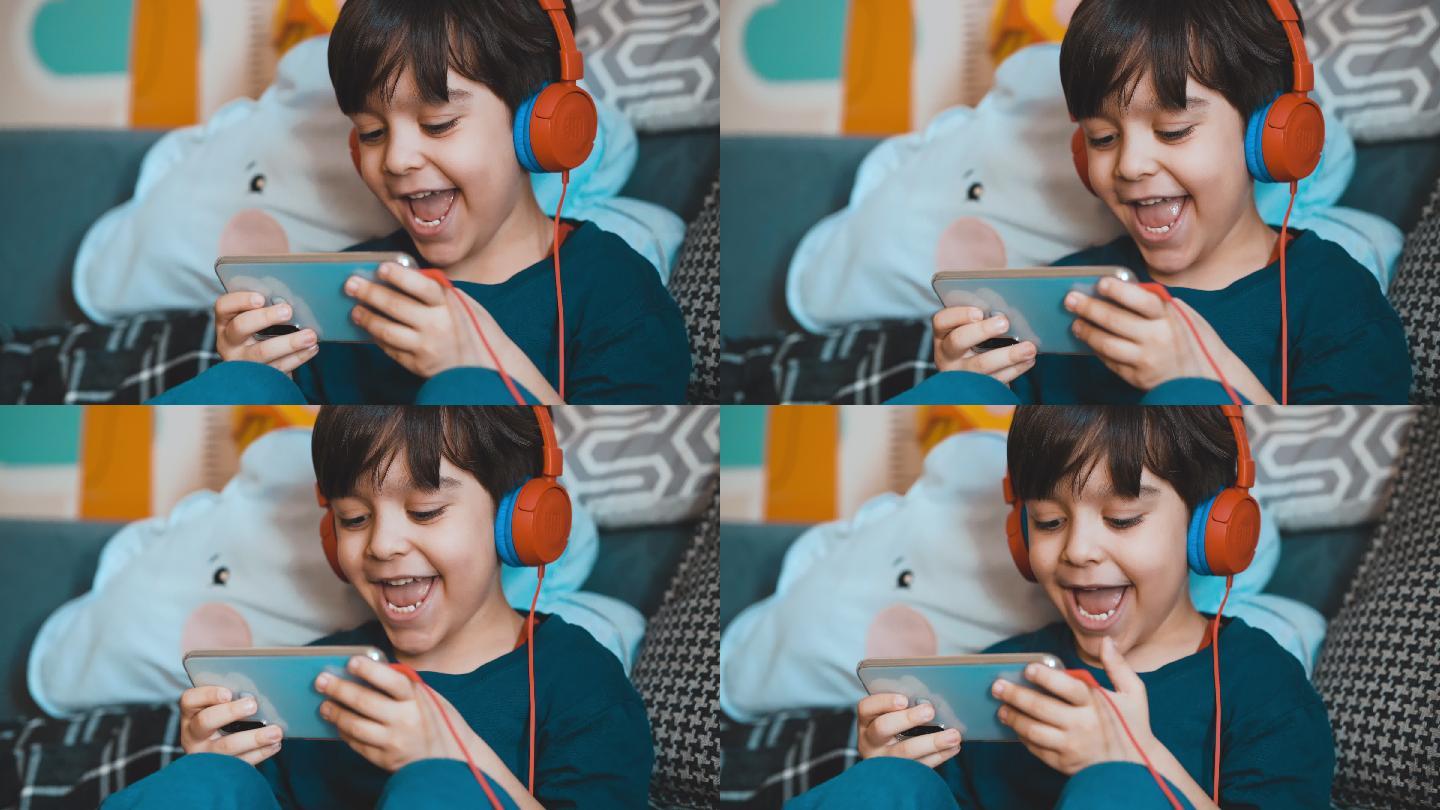 小男孩开心地玩他的手机游戏。