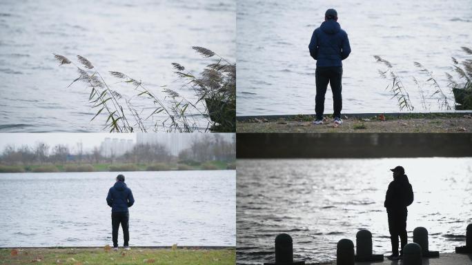 男人一个人站在河边迷茫思考