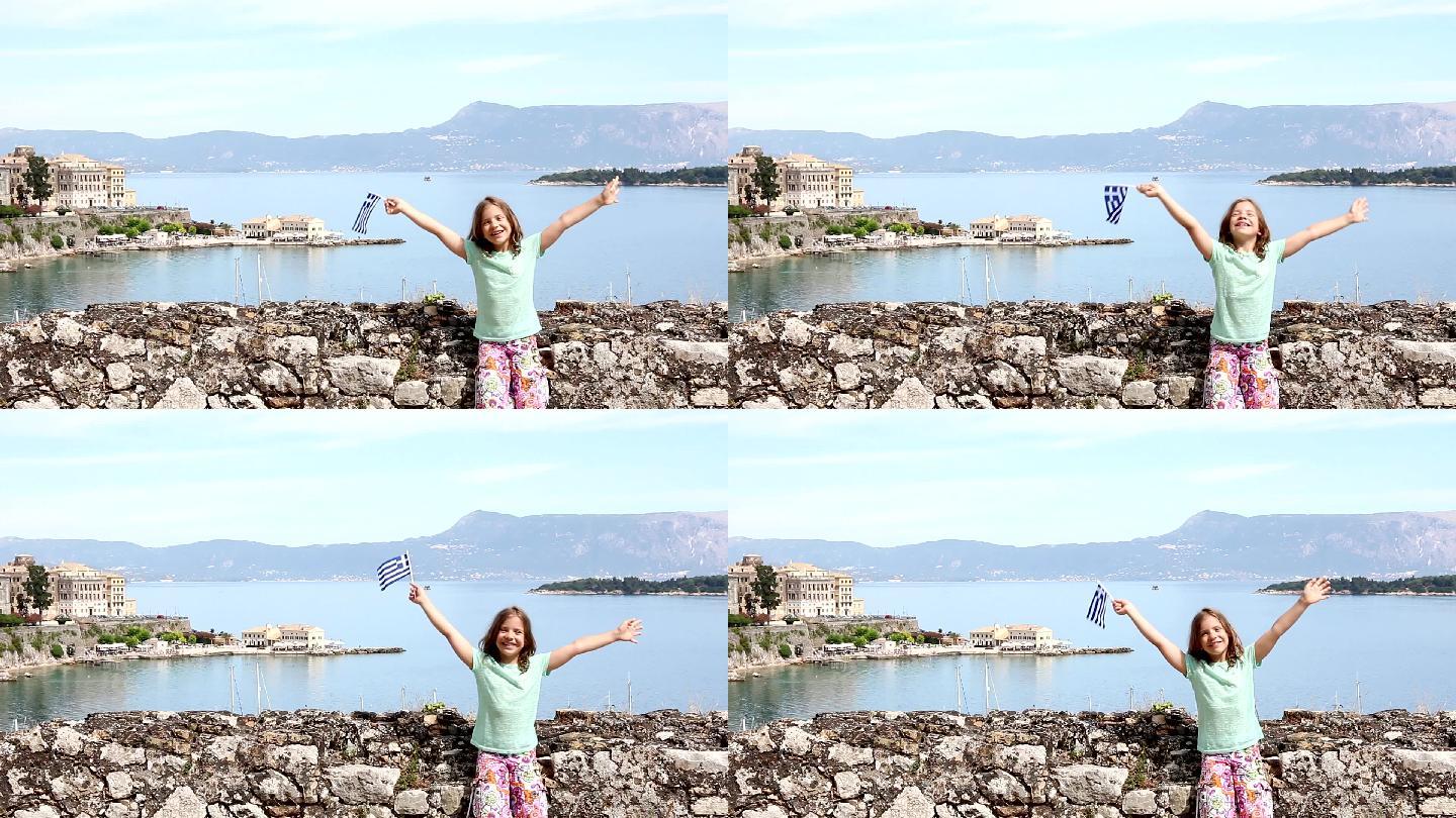 快乐的小女孩挥舞着希腊国旗