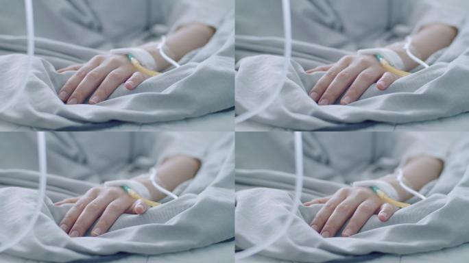 病人的手放在床上看病治病住院部病床输液