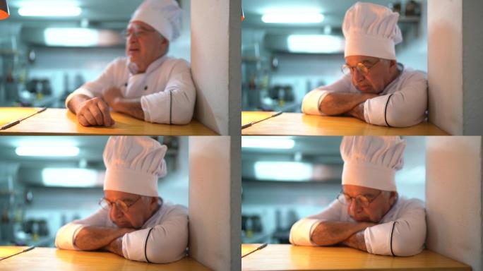 厨房柜台上一位疲惫/焦虑的高级厨师