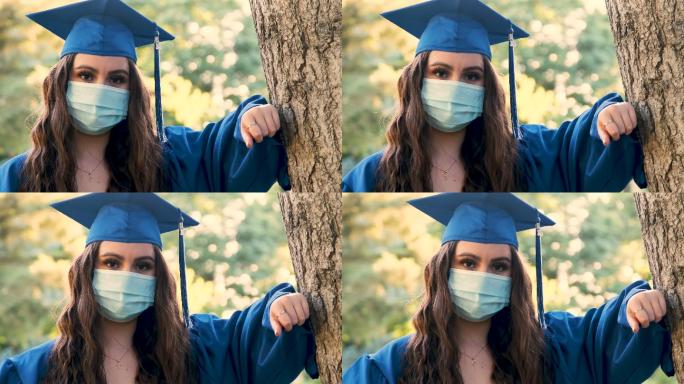 戴着防护面罩庆祝毕业的年轻女子