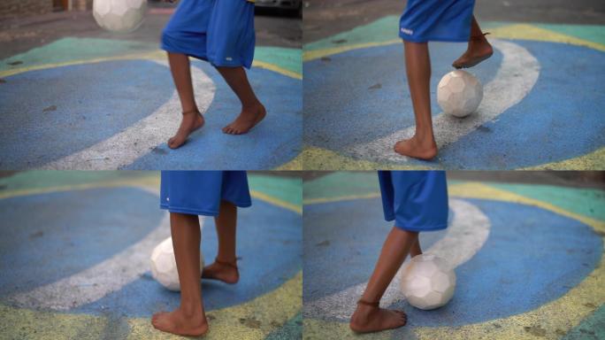 一个孩子在街上踢足球的特写镜头