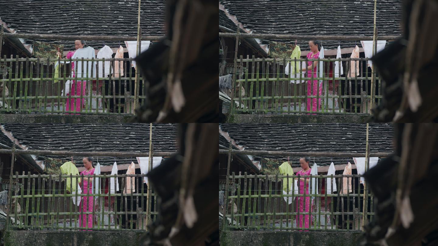 云南村庄在阳台晾衣服的女人