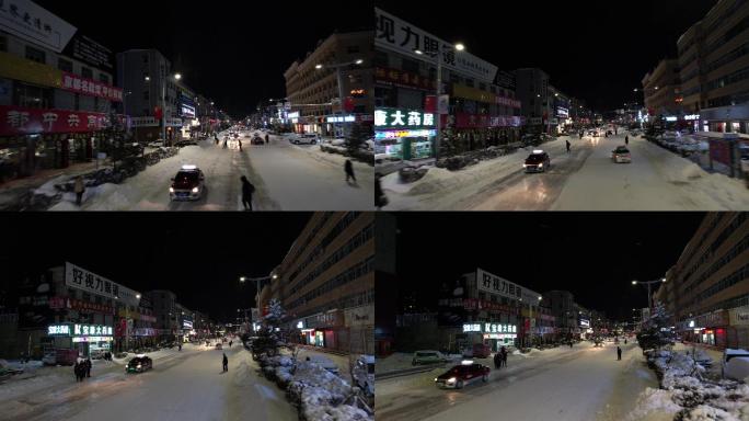 低角度航拍夜晚城市积雪的街道
