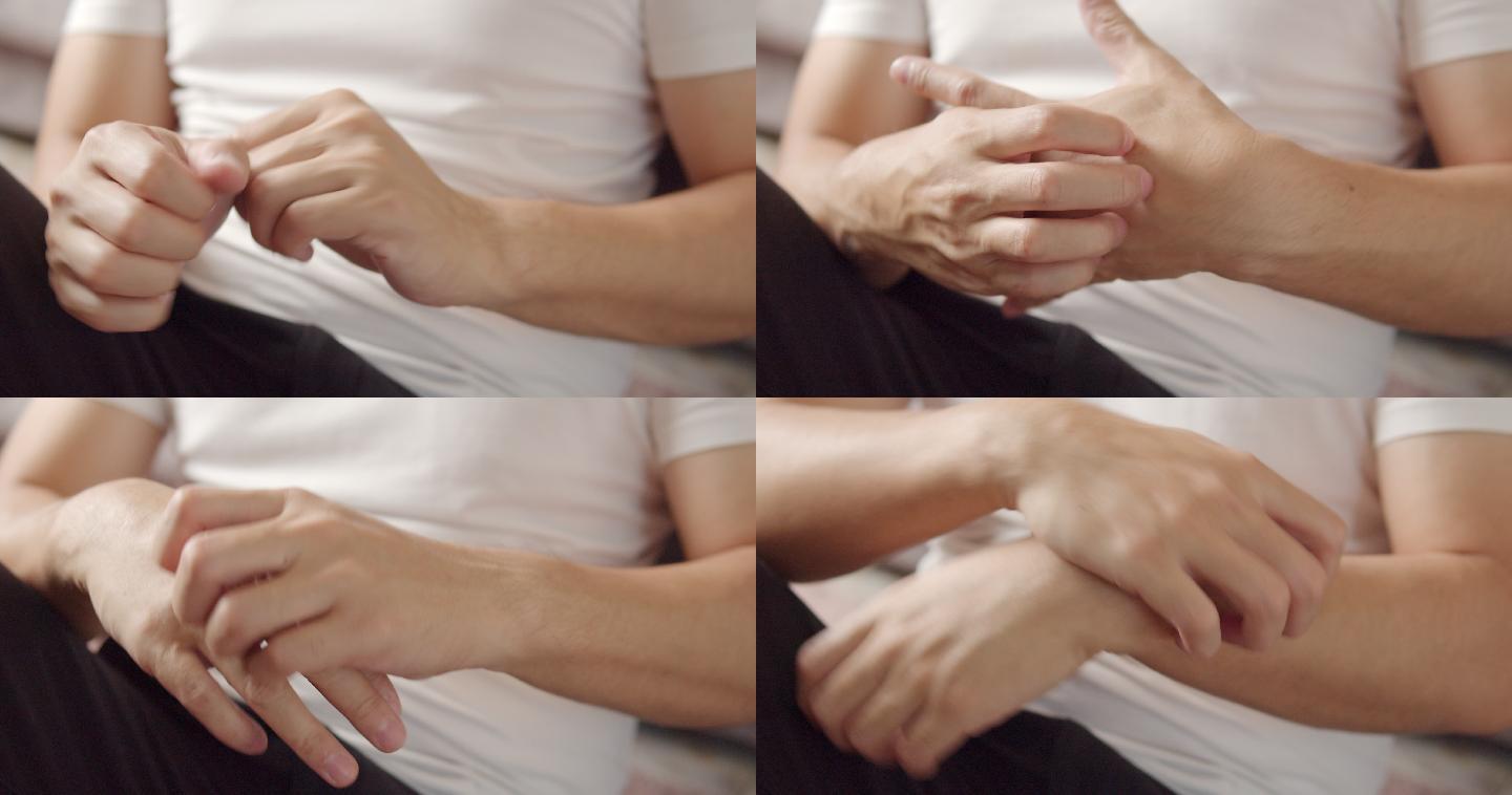 抓挠手部的男人