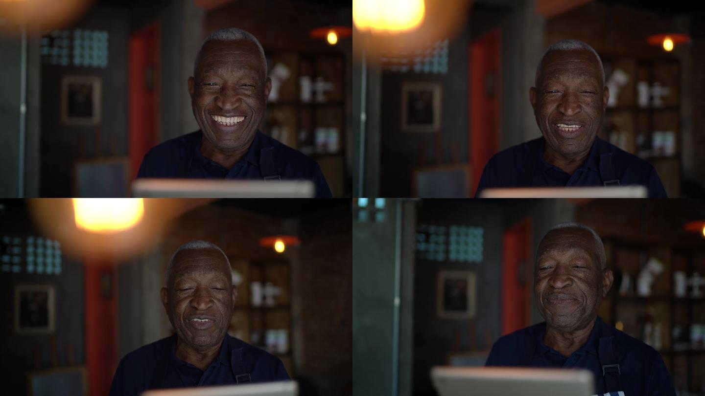 一位微笑的老服务员使用数字平板电脑的画像